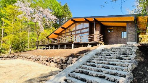 a house with stairs leading up to it at Terrace Villa Foresta Asama in Miyota