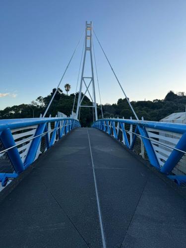 a blue bridge over a body of water at Auckland City cozy Stay in Auckland