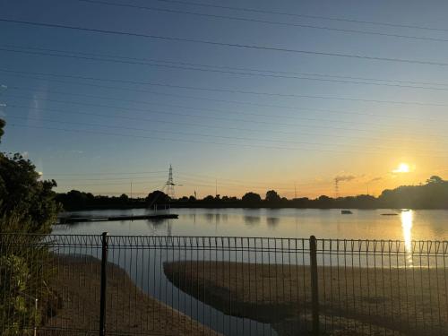a view of a river with the sunset in the background at Auckland City cozy Stay in Auckland