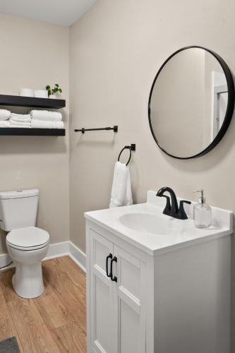 a bathroom with a white sink and a mirror at Parkside Escape in New Albany