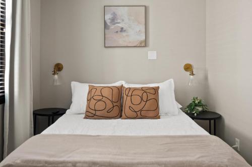 a bedroom with a bed with two pillows on it at Parkside Escape in New Albany