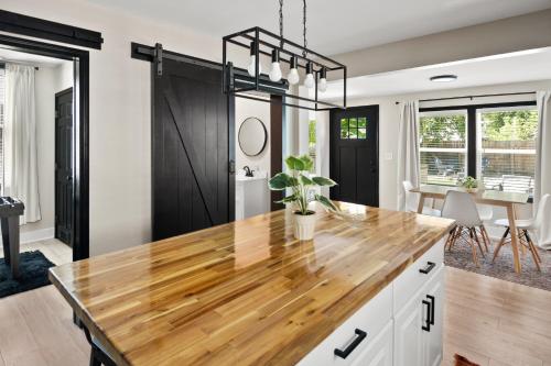 a kitchen with a wooden counter top and a dining room at Parkside Escape in New Albany