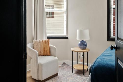 a bedroom with a chair and a lamp and a bed at Parkside Escape in New Albany