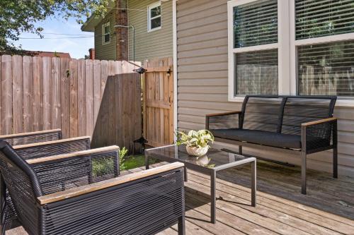 a patio with two chairs and a table and a fence at Parkside Escape in New Albany