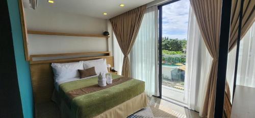 a bedroom with a bed and a large window at Prince Express Inn in Gairan