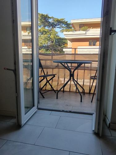 a glass door leading to a patio with a table at Apartaments and Rooms Claudia Augusta in Bolzano