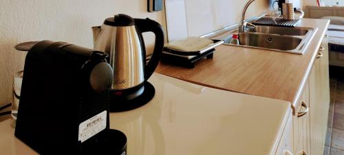 a coffee maker sitting on top of a kitchen counter at Venieri's Stone Villa in Tsagarada