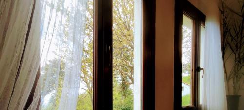 an open window with a view of a tree at Venieri's Stone Villa in Tsagarada
