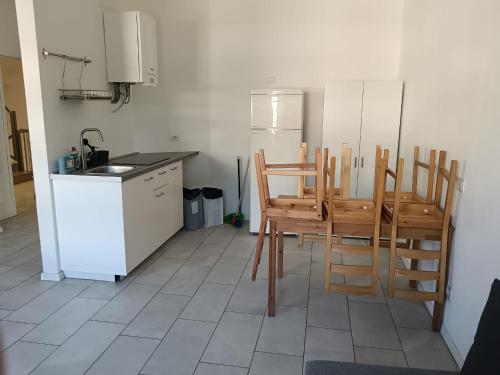 a kitchen with a table and chairs and a refrigerator at Apartaments and Rooms Claudia Augusta in Bolzano