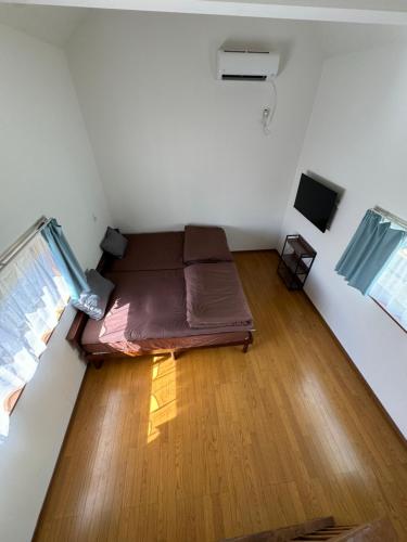 a room with a bed in the middle of a room at コラゾン Resort in Minamidaito