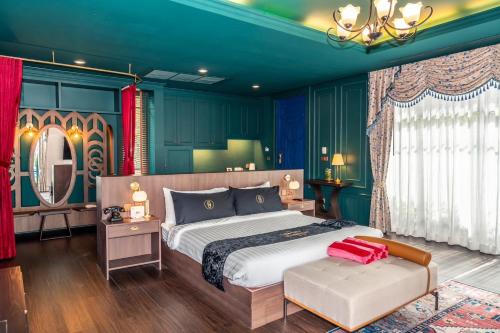 a bedroom with a large bed and a mirror at The Sea-Cret Garden Hua Hin in Hua Hin