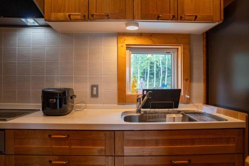 a kitchen with a sink and a window at Best View in Nakafurano