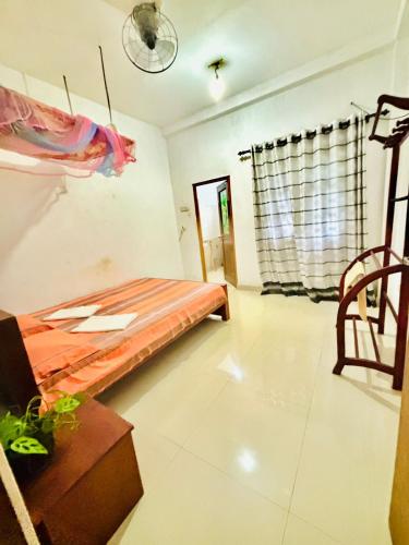 a room with a bed and a chair in it at Sanithu Homestay and villa Galle in Galle