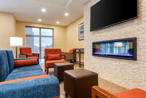 a living room with a tv on a brick wall at Comfort Inn & Suites in Goderich