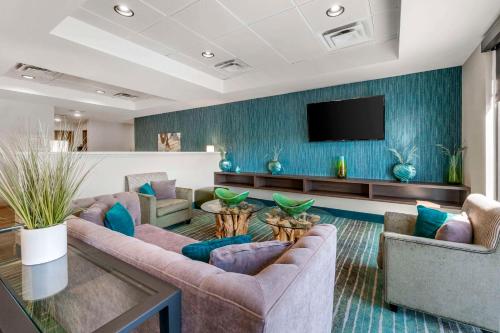 a living room with two couches and a flat screen tv at Comfort Inn & Suites Clarksville - Louisville North in Clarksville