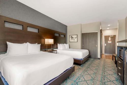 a hotel room with two beds and a television at Comfort Inn & Suites Clarksville - Louisville North in Clarksville