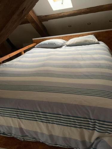 a bed with two pillows on top of it at Studio in Bruyères-le-Châtel