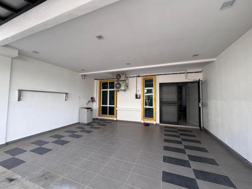 an empty room with a checkered floor at Meera Homestay in Melaka
