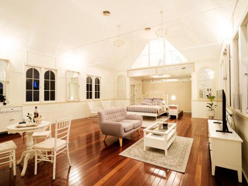 a living room with a couch and a table at Little White Chapel Maleny in Maleny