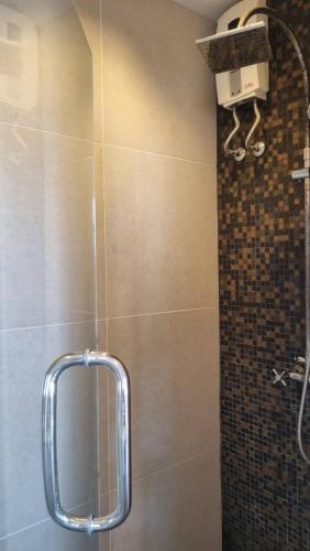 a shower with a mirror in a bathroom at Mosaic condominium AD63M in Ban Tha Fat