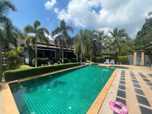 a swimming pool with a pink toy in front of a house at Villa deux chambres avec piscine in Ao Nang