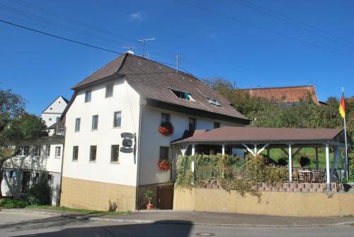 a white house with a gazebo in front of it at Landgasthof Hirschen Untermettingen in Ühlingen-Birkendorf