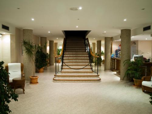 a lobby with a staircase in a building at Aparthotel Villas La Manga in La Manga del Mar Menor