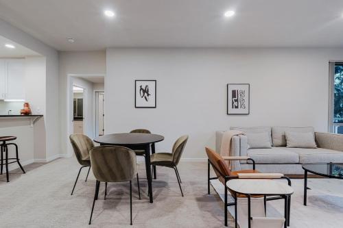 a living room with a couch and a table and chairs at Blueground Santa Clara 2bd apartment SFO-1771 in Milpitas