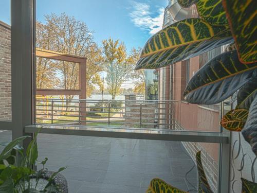 a view from a window of a balcony with a view of a yard at Holiday Beach Budapest Wellness Hotel with Sauna Park in Budapest
