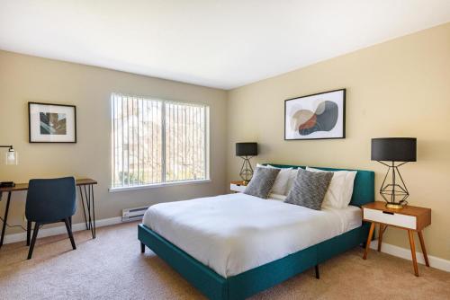 a bedroom with a bed and a desk and a window at Blueground Santa Clara pool nr tech hub shops SFO-1672 in Santa Clara