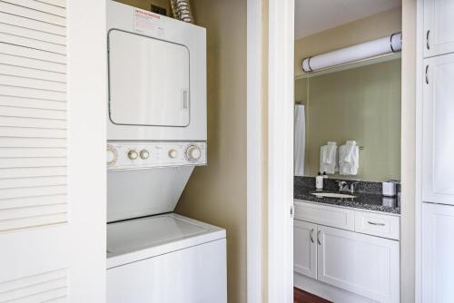 a white laundry room with a washer and dryer at Blueground Santa Clara pool nr tech hub shops SFO-1672 in Santa Clara