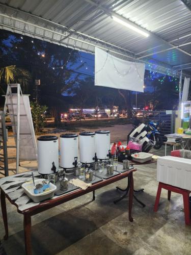 a table with three white tanks on top of it at Homestay Zaishazali in Gelugor
