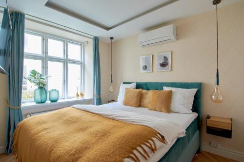 a bedroom with a bed with a large window at Cherryy in Copenhagen