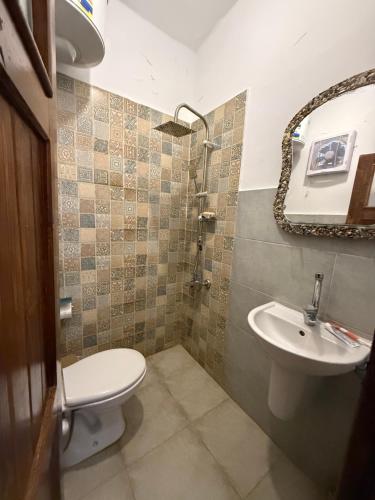 a bathroom with a toilet and a sink at Sukoon Nuweibaa in Nuweiba