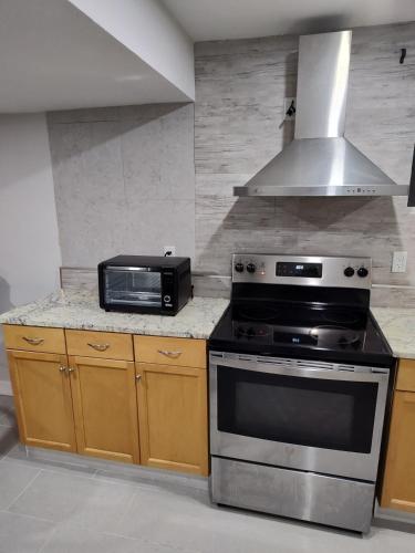 a kitchen with a stove and a microwave at Chamber Inn in Edmonton