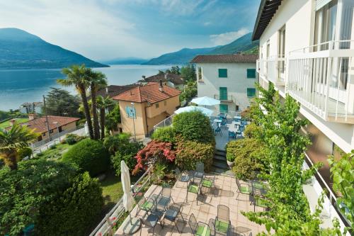 an apartment balcony with a view of the water at Garden Hotel Primavera in Brissago
