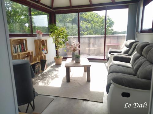 una sala de estar con un sofá y una mesa en Maison paisible Le Dali, en Piolenc