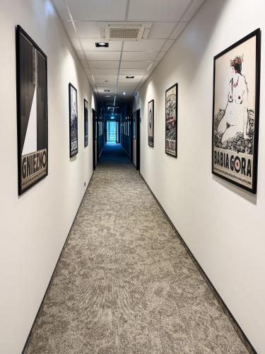a hallway with framed art on the walls at Sarmata in Czyżówek