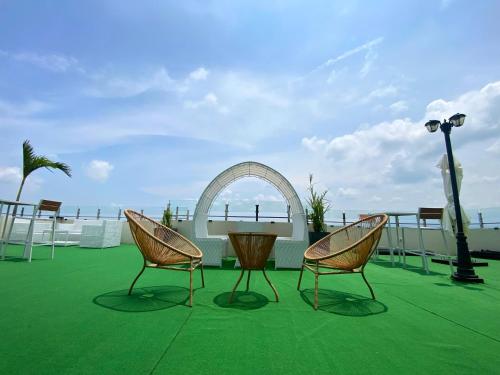 two chairs and a table on top of a roof at El Coco Boutique Hotel in Ibabang Talim