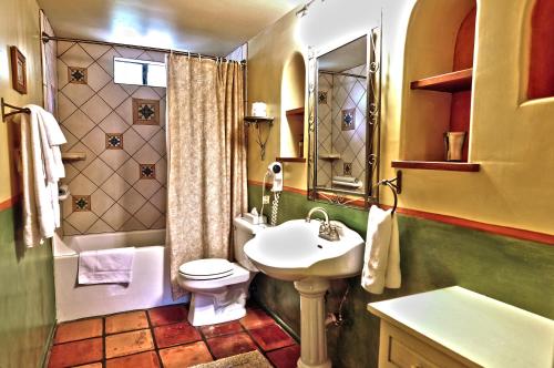 a bathroom with a white sink and a toilet and a sink at Blue Iguana Inn in Ojai