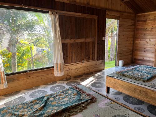 a bedroom with two beds and a large window at Peaceful Hill Homestay in Ke Ga