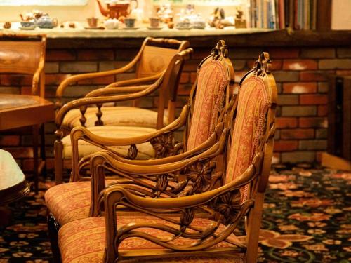 a row of wooden chairs sitting in a room at Sasara in Gero