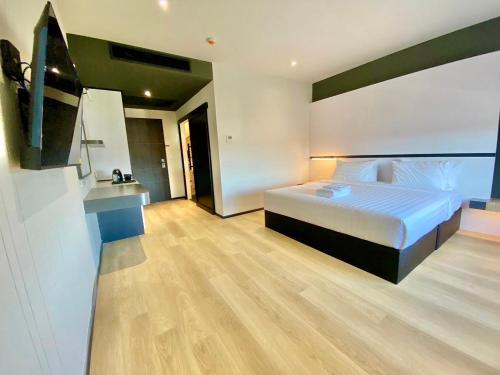a bedroom with a bed and a television in it at 9D City & 9D Express Hotel in Udon Thani