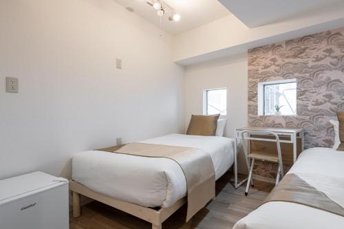 Postel nebo postele na pokoji v ubytování 東新宿 1110