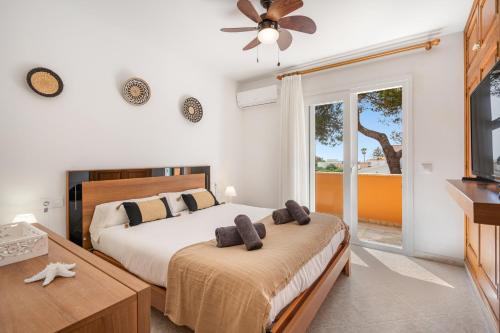 a bedroom with a bed and a large window at Villa Cristina in Cala Blanca