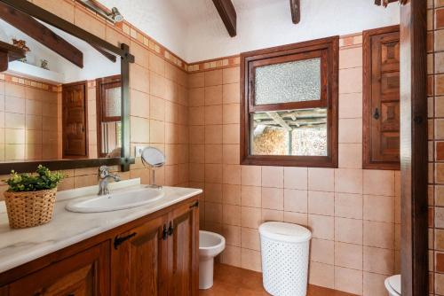 a bathroom with a sink and a toilet at Villa Can Biel by Escape Home in Cala Morell