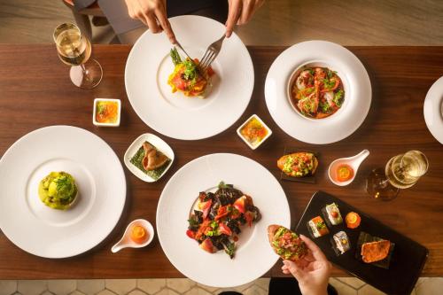 a wooden table with plates of food on it at Fairmont Chengdu in Chengdu