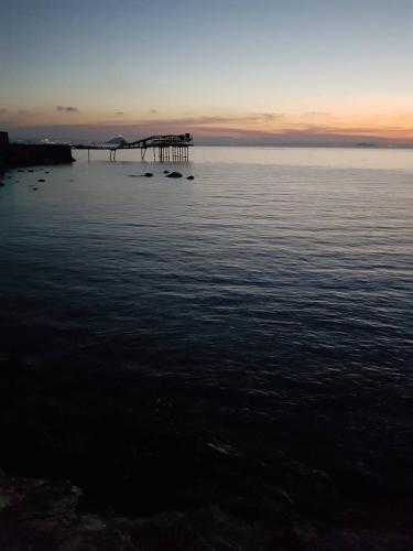a large body of water with a pier in the distance at Monolocale con veranda e giardino a Rio Marina in Rio Marina