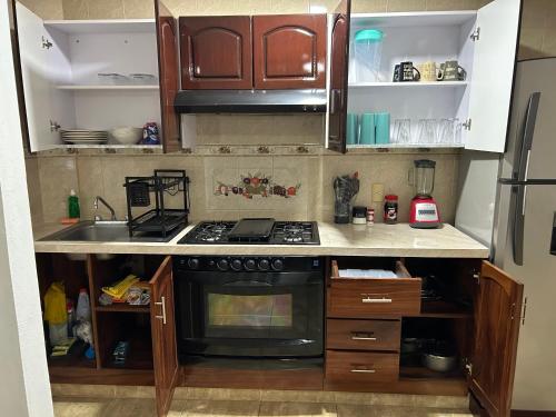 a kitchen with a stove and a sink at Hermosa Casa Con Alberca AC in Ixtapa