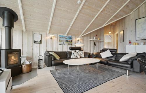 a living room with a couch and a table at Holiday Home Vandstedet Ix in Nordborg